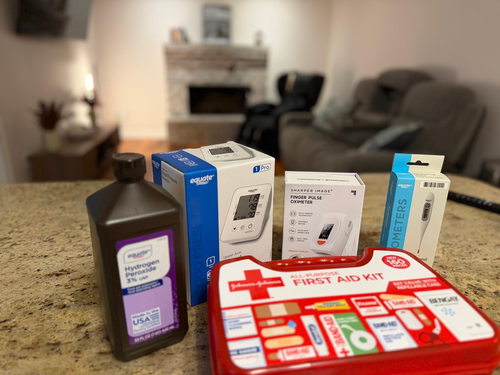 Guest kit with an upper-arm blood pressure monitor, pulse oximeter, thermometer, and first aid kit